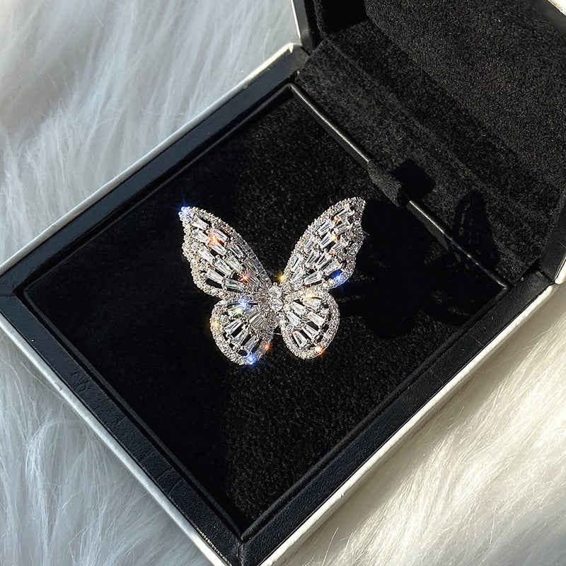 Dignified Fashion Hollow Butterfly Ring in a black display box, featuring sparkling crystals and a unique butterfly design.